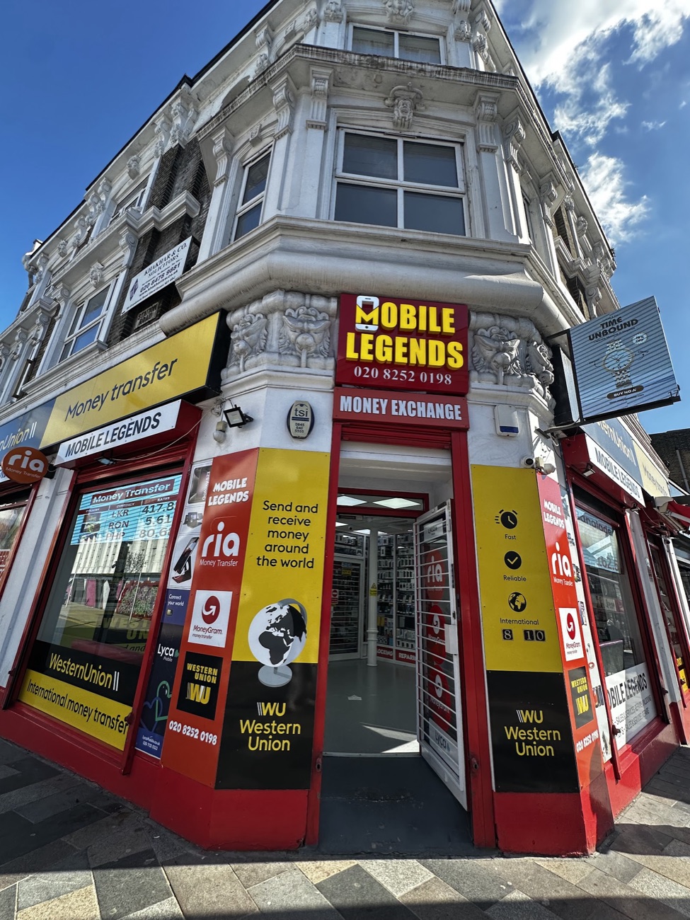 The Mobile Legends shopfront on the corner of Cranbrook Road, Ilford, with its red and gold fascia, phone icon and Money Exchange signage.